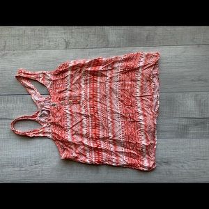 Sleeve less it’s peach/orange and white top